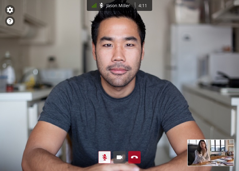 The redesigned video call screen: the remote participant full-bleed, a slim bar naming them with signal strength and elapsed time, settings and help buttons tucked in the top corner, mute, camera and hang-up controls centered at the bottom, and a self-view thumbnail in the lower right